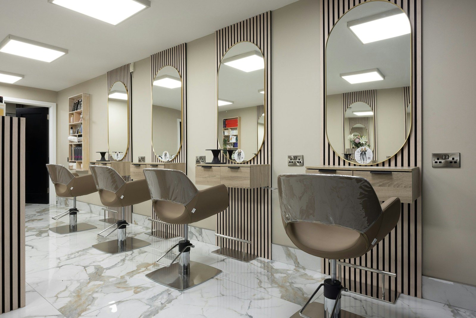 Elegant salon styling stations with gold-framed mirrors
