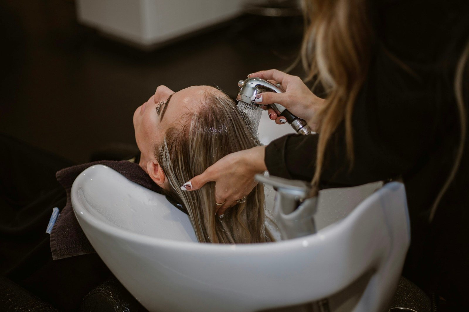 Guest relaxing during a hair wash at the salon
